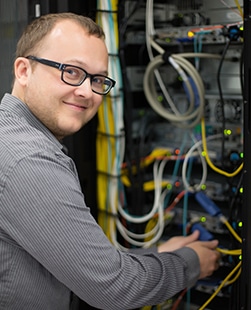 An electrical engineer monitoring a networking system