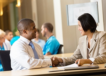 Professional business people shaking hands during job interview