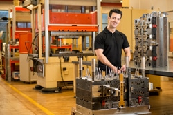 A professional toolmaker looking at camera and smiling