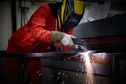 Plasma Operator Using a Cutter in Steel Fabrication Factory