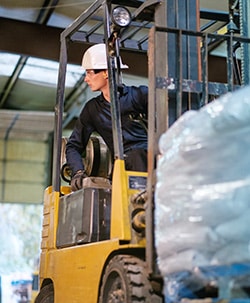 Forklift Operator at a Warehouse Lifting Items