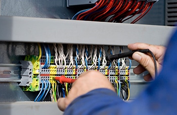 Electrician at work with his instrument