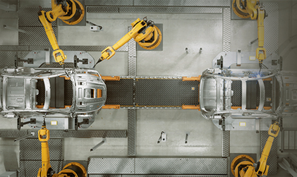 Robotic arms assembling vehicle components representing automation and advanced hiring solutions in the industrial sector.