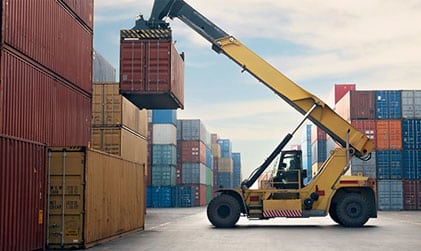Forklift operating in a shipping yard, representing staffing solutions for logistics, industrial, and warehouse sectors.