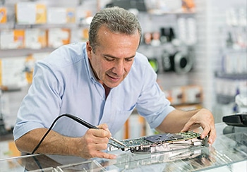 IT Technician Fixing a Motherboard