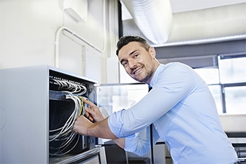 An electrical engineer making sure all cables are connected properly