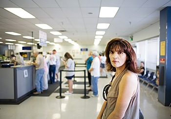 Female Waiting In Line To Speak With A Clerk