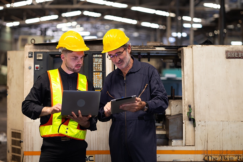 Engineers discussing technical plans for underwater welding projects in a marine construction setting.